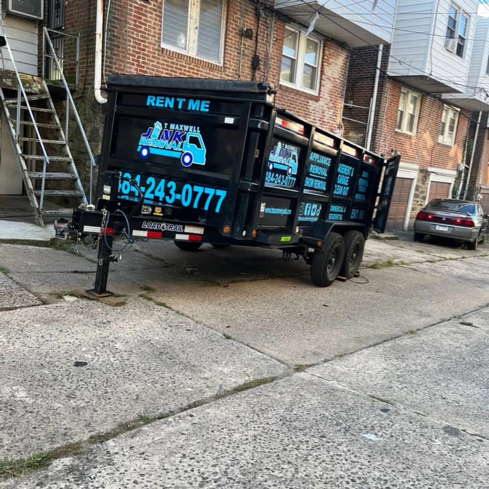 T Maxwell U-Loader dumpster parked at a Delaware County property