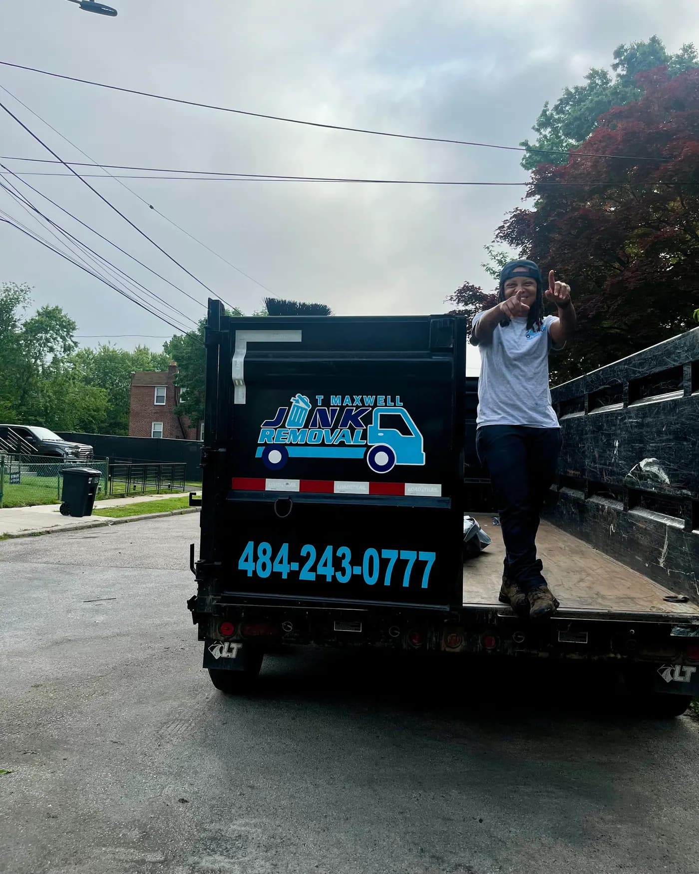 Tee Maxwell, owner of T Maxwell Junk Removal & Cleanouts, on her branded dump trailer